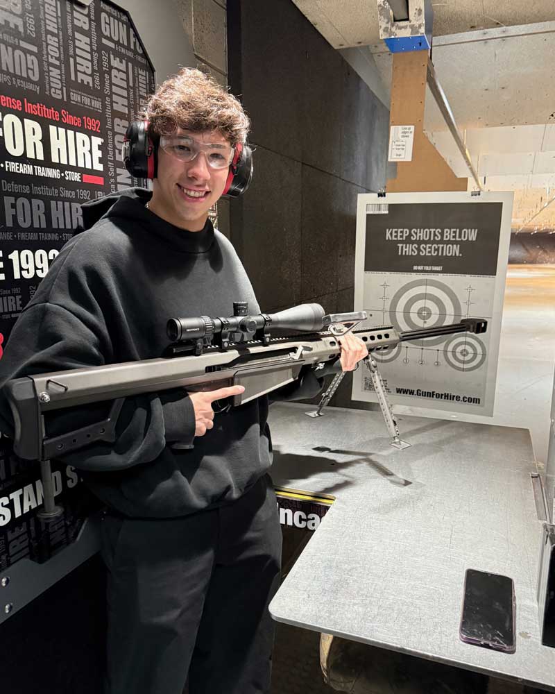 Smiling family enjoying their first time shooting at Gun For Hire’s 6-Star indoor range